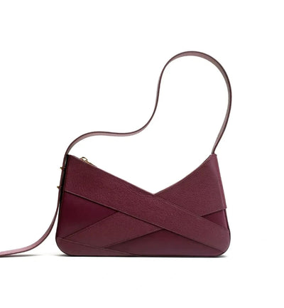 The aubergine Lulu leather handbag from Studio DRÈA that was featured in Fashionista shopping list agains a white background.