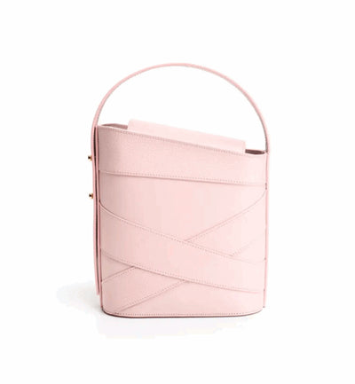 The light pink Violette handbag in italian leather from Studio DRÈA that was featured in the Numero Magazine as one of the trend of the season against a white background