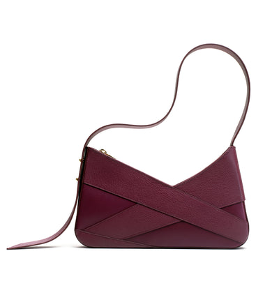 Aubergine leather shoulder handbag from Studio DRÈA ribbon collection featured in the Vanguard Magazine print edition from june 2026.